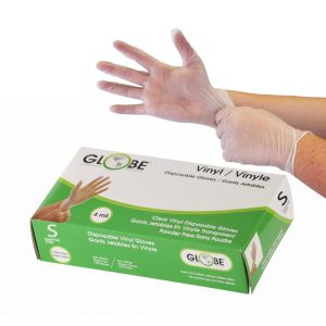 Two hands putting on clear, vinyl gloves with a green and white box of them.